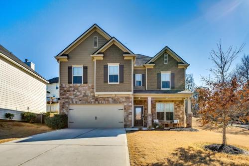 a house with a garage in front of it at Open Plan Arcade Home with Natural Hardwoods Sleeps 10 in Atlanta