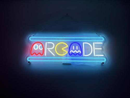 a neon sign with the words ragnarride on it at Open Plan Arcade Home with Natural Hardwoods Sleeps 10 in Atlanta