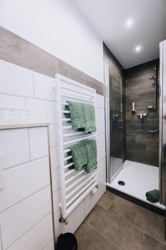 a bathroom with a shower and a bath tub at Pension Bavaria in Mittenwald