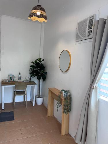a room with a table and a mirror on the wall at The Shark's Tail Dive Resort in Malapascua Island