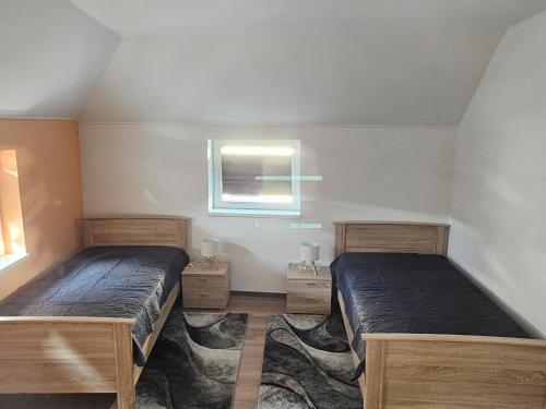 a bedroom with two beds and a window at Moni's Ferienwohnung in Hammelburg