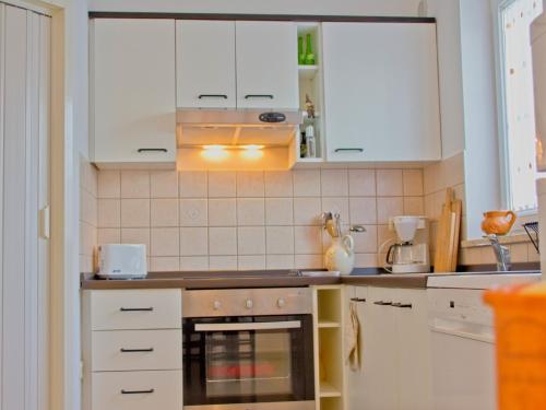 a kitchen with white cabinets and an oven at Casa Allure in Višnjan