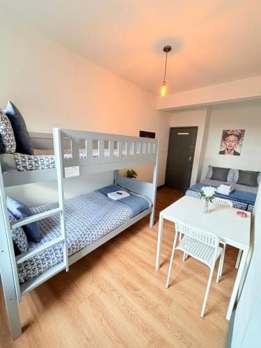a room with two bunk beds and a table at Kilburn Guest Rooms 167 in London