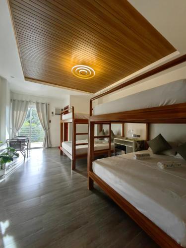 a bedroom with two bunk beds and a ceiling at Dream'Star Resort in Puerto Galera