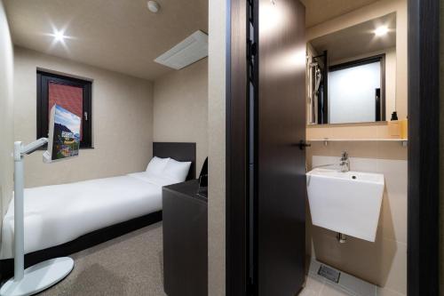 a hotel room with a bed and a sink at 해치 호스텔 in Seoul