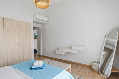 a white room with a bed and a mirror at The Sandy Feet Sea Front in Hurghada