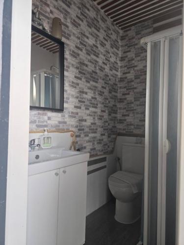 a bathroom with a sink and a toilet and a mirror at SALTILLO ALTO WHITE STUDIO in Torremolinos