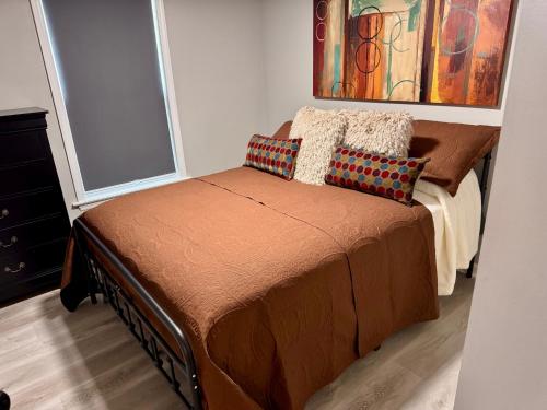 a bedroom with a bed with two pillows on it at Convenient 3 bedroom Townhome in Raleigh