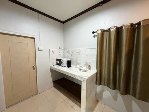 a bathroom with a sink and a microwave on a counter at Kiriraya Resort in Ao Nang Beach