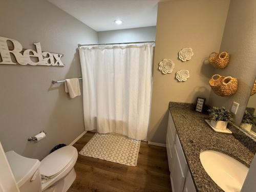 a bathroom with a toilet and a sink and a shower at Branson Ridge Retreat in Branson