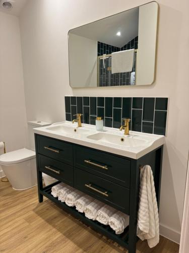 a bathroom with a sink and a mirror at The Brambles bungalow in Weston-super-Mare