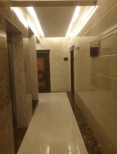 a hallway with a room with a toilet and a light at اجنحة سبات الفندقيه in Ahad Rafidah