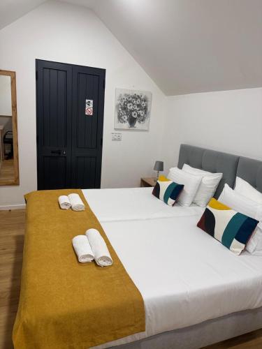 a bedroom with two beds with towels on them at Cozy House in Funchal