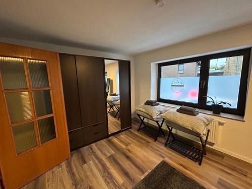 a living room with a table and a large window at Ferienwohnung Clemens in Nideggen