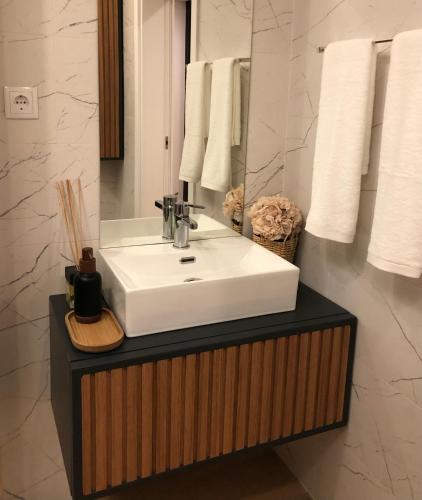 a bathroom with a white sink and a mirror at Quinta do Barrocal - Casa de Campo in Peso da Régua