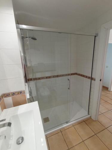 a glass shower in a bathroom with a sink at Vinaros Cala Montero 2 in Vinarós