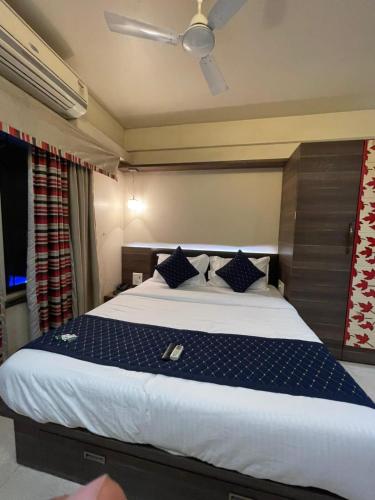 a bedroom with a large bed with a blue comforter at Tejas 4 Bhk Villa in Pune