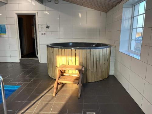 a wooden tub with a wooden chair in a bathroom at 5 star holiday home in Øster Assels in Øster Assels