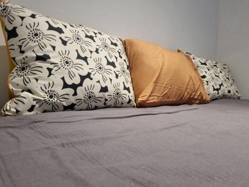 a bed with two pillows on top of it at Container home in San Rafael