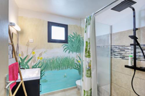 a bathroom with a shower with a painting on the wall at Dragon Fly Location saisonnier in Le Tampon