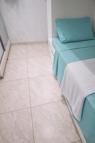 a room with two beds and a tiled floor at Doce Lar São Francisco in Cabo de Santo Agostinho