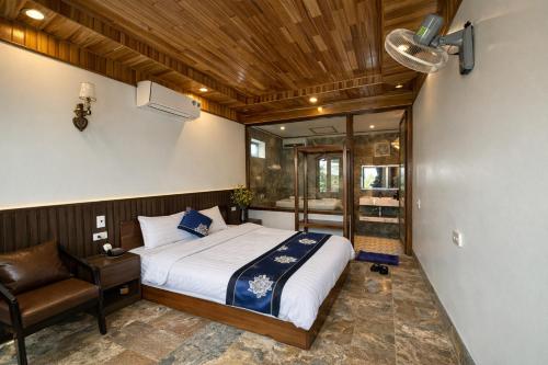 a bedroom with a bed and a chair in it at Senna Garden Homestay in Xuân Sơn
