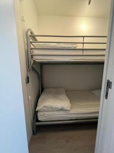 a small room with a bunk bed in it at JuLieze Apartment at Sea & Pool in Ostend