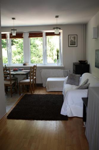 a living room with a bed and a table and a couch at Apartament Kolberga w Sopocie in Sopot