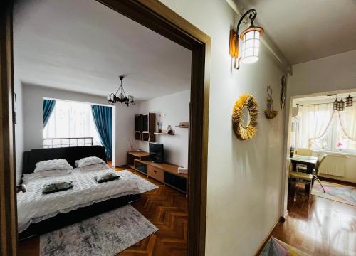 a bedroom with a bed and a mirror at Apartament Centru in Cugir