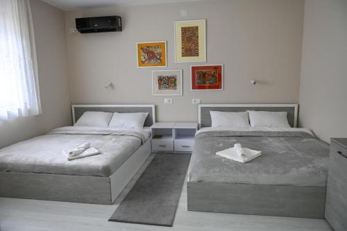 a bedroom with two beds with white towels on them at Solaris Apartment in Bitola