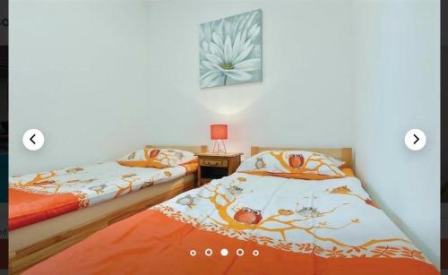 two beds sitting next to each other in a room at VILA LASOVIC + POOL + JACUZZI + SAUNA in Tuhelj