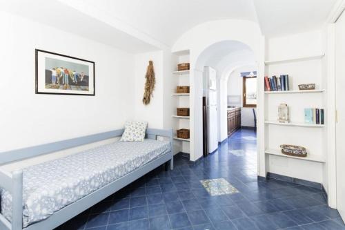 a bedroom with a bed and a blue tile floor at La Cantina in Ventotene