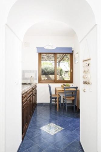 a kitchen with a table and a dining room at La Cantina in Ventotene