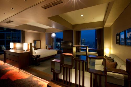 a bedroom with a bed and a room with a view at The Royal Park Hotel Iconic Tokyo Shiodome in Tokyo