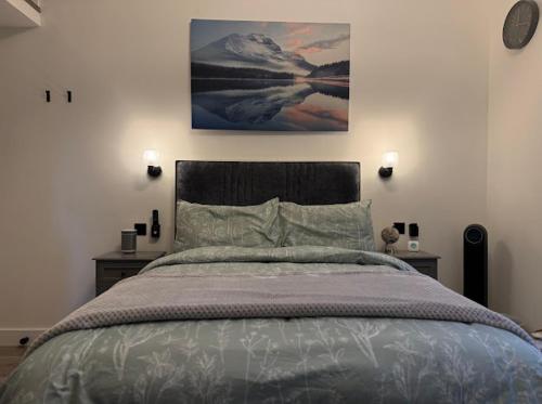 a bedroom with a large bed with two night stands at Brand new modern, quirky and stylish studio apartment in Sheffield
