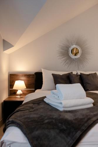 a bedroom with a bed with a mirror on the wall at Czantoria View Apartment Ustroń in Ustroń