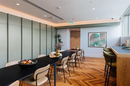 a conference room with a long table and chairs at The Mercian by Your Perfect Stay Birmingham - Apart-Hotel Style - 24-Hour Reception & Gym in Birmingham