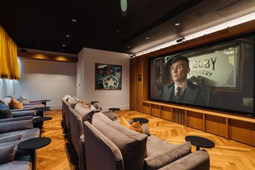 a waiting room with couches and a large screen at The Mercian by Your Perfect Stay Birmingham - Apart-Hotel Style - 24-Hour Reception & Gym in Birmingham