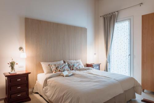 a bedroom with a large bed and a window at Ca' del Volo in Grezzana