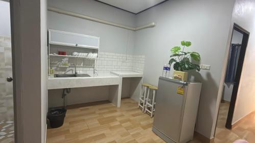 a kitchen with a sink and a refrigerator in a room at Solara เฮ้าส์ in Ban Nong Saeng (4)