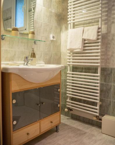 a bathroom with a sink and a shower at Villa Tzitzifies in Kouroukláta