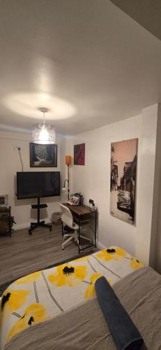 a bedroom with a bed and a flat screen tv at The Shinki House in Nottingham