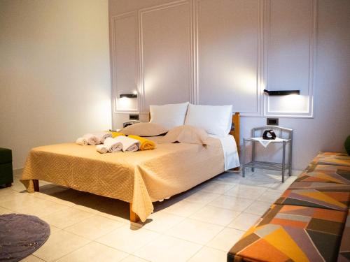 a bedroom with a bed with two towels on it at Villa Tzitzifies in Kouroukláta