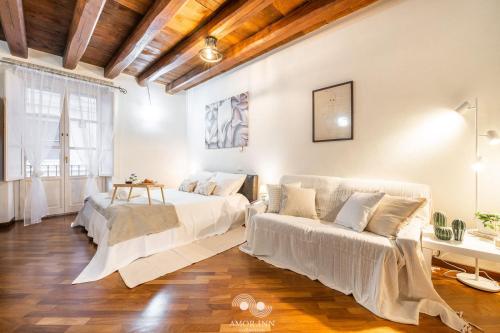 a living room with two beds and a couch at Casa Vacanza Pablo Castello in Cagliari
