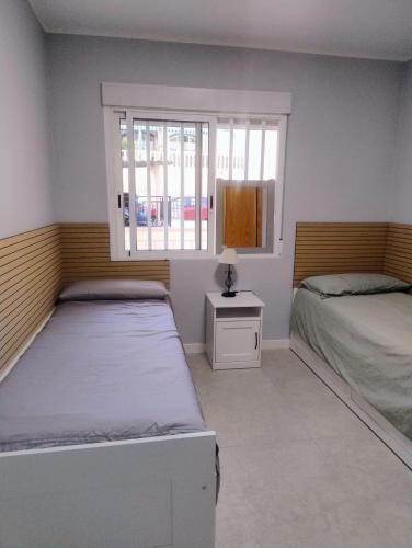a bedroom with two beds and a window at Casanova in Calpe