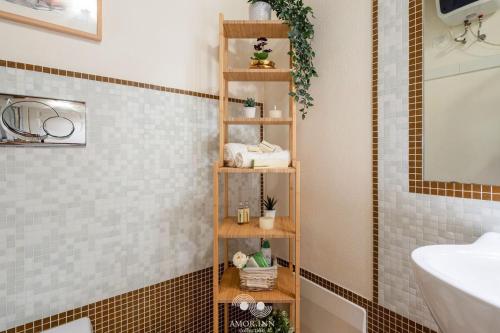 a bathroom with a wooden shelf with towels and plants at Casa Vacanza Pablo Castello in Cagliari