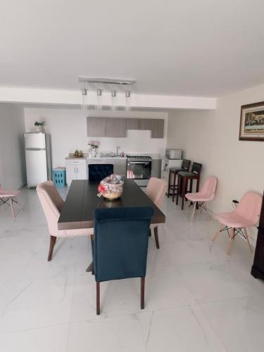 a kitchen with a table and chairs in a room at Casa Analco Durango in Durango