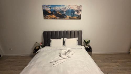 a stuffed animal laying on top of a bed at Mountain View Apartment&Parking in Râşnov