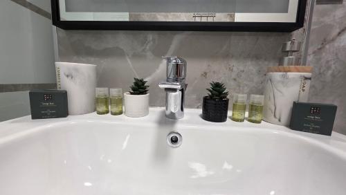 a bathroom sink with a faucet and candles on it at Mountain View Apartment&Parking in Râşnov