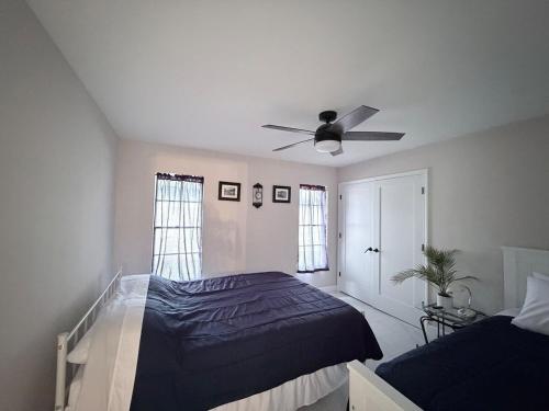 a bedroom with a bed and a ceiling fan at Sunshine house on the canal in North Fort Myers
